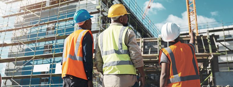 Shot of a group of builders assessing progress at a construction site